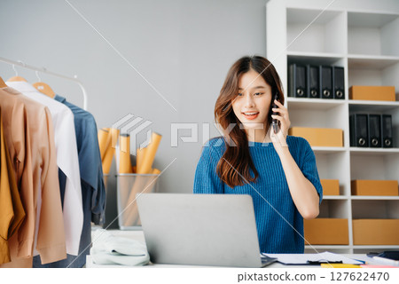 Startup small business SME, Entrepreneur owner woman using smartphone or tablet taking receive and checking online purchase shopping order Startup small business SME, Entrepreneur owner woman using smartphone or tablet taking receive and checking online purchase shopping order 127622470