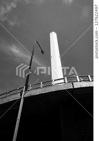 Looking up at street lights and tall chimneys b-6 monochrome 127622497
