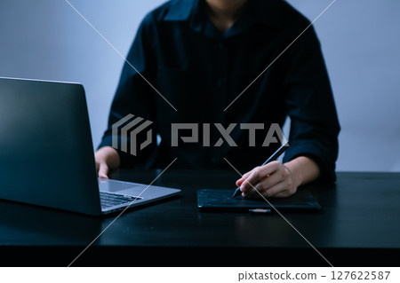 Businesswoman hand using laptop, tablet and smartphone in office. Digital marketing media mobile app and discussing plan new start up project. 127622587