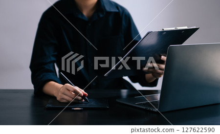 Businesswoman hand using laptop, tablet and smartphone in office. Digital marketing media mobile app and discussing plan new start up project. 127622590