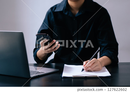 Businesswoman hand using laptop, tablet and smartphone in office. Digital marketing media mobile app and discussing plan new start up project. Businesswoman hand using laptop, tablet and smartphone in office. Digital marketing media mobile app and discussing plan new start up project. 127622602
