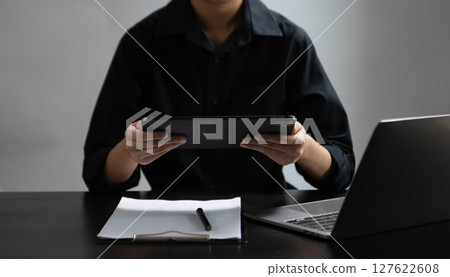 Businesswoman hand using laptop, tablet and smartphone in office. Digital marketing media mobile app and discussing plan new start up project. Businesswoman hand using laptop, tablet and smartphone in office. Digital marketing media mobile app and discussing plan new start up project. 127622608