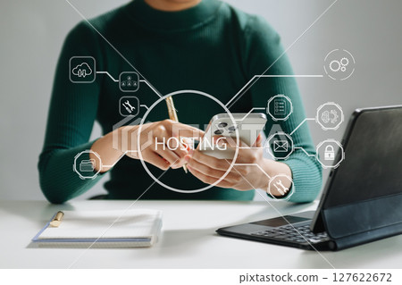 Web hosting concept, woman using computer, tablet and presses his finger on the virtual screen inscription Hosting on desk, Internet, business technology concept. Web hosting concept, woman using computer, tablet and presses his finger on the virtual screen inscription Hosting on desk, Internet, business technology concept. 127622672