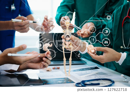 Medical technology network team meeting concept. Doctor hand working with smart phone modern digital tablet and laptop computer with graphics chart interface, with virtual icon Medical technology network team meeting concept. Doctor hand working with smart phone modern digital tablet and laptop computer with graphics chart interface, with virtual icon 127622718
