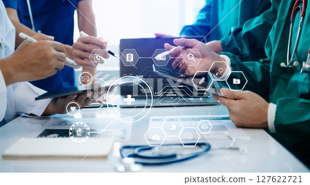 Medical technology network team meeting concept. Doctor hand working with smart phone modern digital tablet and laptop computer with graphics chart interface, with virtual icon Medical technology network team meeting concept. Doctor hand working with smart phone modern digital tablet and laptop computer with graphics chart interface, with virtual icon 127622721
