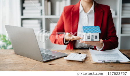 Signing a contract. Client and broker agent, lease agreement, successful deal and Young business sitting at the desk in office Signing a contract. Client and broker agent, lease agreement, successful deal and Young business sitting at the desk in office 127622767