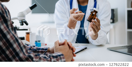 medical doctor holing patient's hands and comforting her.Kind doctor giving real support for patient. In clinic 127622822