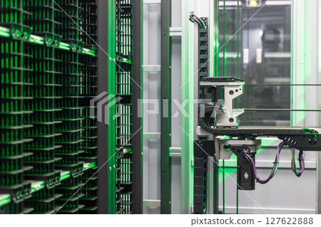 Automated industrial storage system with green light, Smart warehouse automation modern storage and retrieval system, Industry 4.0 automated robotic storage warehouse. Automated industrial storage system with green light, Smart warehouse automation modern storage and retrieval system, Industry 4.0 automated robotic storage warehouse. 127622888