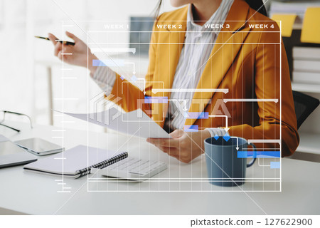 Project manager working and update tasks with milestones progress planning and Gantt chart scheduling diagram. business working with smart phone, tablet and laptop Project manager working and update tasks with milestones progress planning and Gantt chart scheduling diagram. business working with smart phone, tablet and laptop 127622900