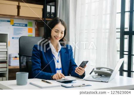 Portrait of female office businesswoman startup daydreaming about her work, startup and working with laptop on office desk in office 127623004