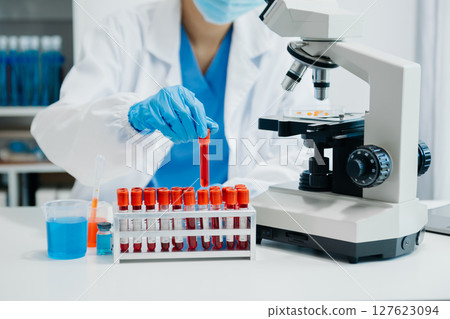 Modern medical research laboratory. female scientist working with micro pipettes analyzing biochemical samples, advanced science chemical laboratory Modern medical research laboratory. female scientist working with micro pipettes analyzing biochemical samples, advanced science chemical laboratory 127623094