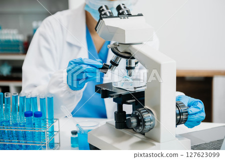 Modern medical research laboratory. female scientist working with micro pipettes analyzing biochemical samples, advanced science chemical laboratory Modern medical research laboratory. female scientist working with micro pipettes analyzing biochemical samples, advanced science chemical laboratory 127623099