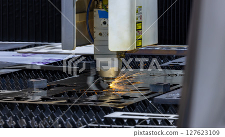 CNC laser cutting machine precision metal fabrication technology modern industry, High precision CNC laser cutting machine industrial metal sheet fabrication with spark. CNC laser cutting machine precision metal fabrication technology modern industry, High precision CNC laser cutting machine industrial metal sheet fabrication with spark. 127623109