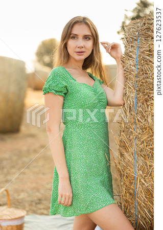 Young woman in dress standing during picnic 127623537