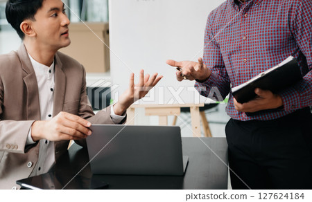 working together on a project two young business colleagues working on a computer at modern office working together on a project two young business colleagues working on a computer at modern office 127624184