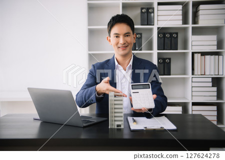 Asian man working with House model real estate agent and customer discussing for contract to buy house, insurance or loan real estate consult concerning mortgage loan offer Asian man working with House model real estate agent and customer discussing for contract to buy house, insurance or loan real estate consult concerning mortgage loan offer 127624278