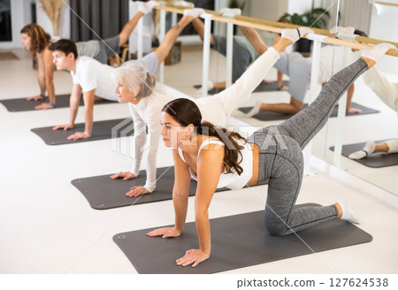 Group of different ages healthy lifestyle practicing pilates at studio Group of different ages healthy lifestyle practicing pilates at studio 127624538