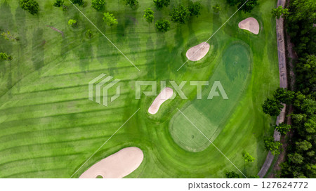 Aerial view golf course with lush greens, putting green, fairway and sand bunker, Golf course green grass and trees fairway and putting green, Beautiful golf course. 127624772