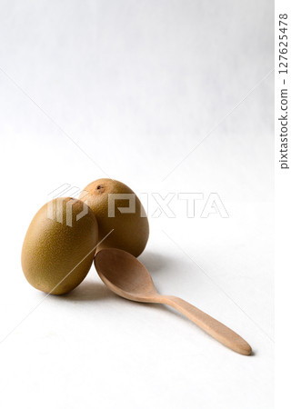 Fresh kiwi fruit with wooden spoon on white background, Healthy eating Fresh kiwi fruit with wooden spoon on white background, Healthy eating 127625478