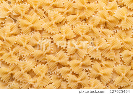 Raw farfalle pasta scattered in a seamless texture background,, Italian food ingredient Raw farfalle pasta scattered in a seamless texture background,, Italian food ingredient 127625494