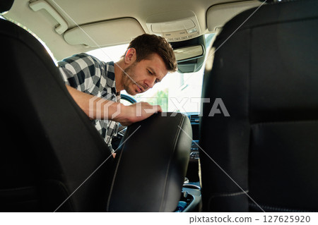 Man inspecting car interior 127625920