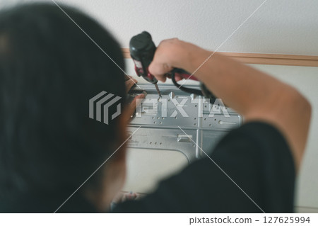 Temporarily attach the back panel of the indoor unit of the room air conditioner Temporarily attach the back panel of the indoor unit of the room air conditioner 127625994
