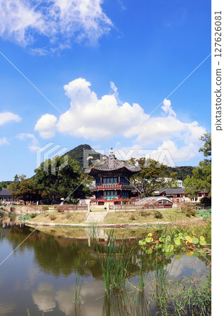 Landscape with ancient pavilion, mountains and lake. Hyangwonjeong Pavilion in the pond, garden of Gyeongbokgung palace, Seoul, South Korea. Topic of travel, trip abroad on vacation, cruises and tours 127626081