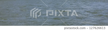 Serene Water Surface A Tranquil Scene of Ripples and Reflections for Background Use Serene Water Surface A Tranquil Scene of Ripples and Reflections for Background Use 127626613