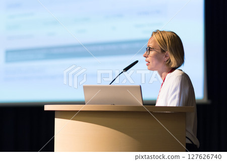 Female speaker giving a talk on corporate business conference. Business and Entrepreneurship event 127626740