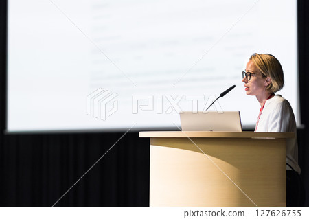 Female speaker giving a talk on corporate business conference. Business and Entrepreneurship event 127626755