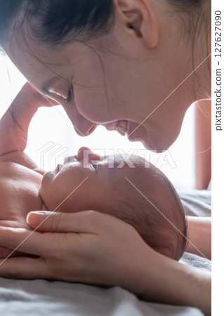 Tender Moment Between Mother and Newborn 127627090