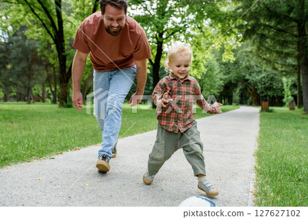Father lining up to have a running race with his little son. Father lining up to have a running race with his little son. 127627102