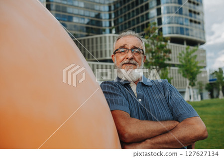 Confident senior man standing in the middle of street. 127627134