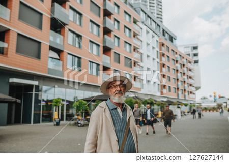Confident senior man standing in the middle of street. Confident senior man standing in the middle of street. 127627144