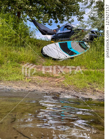 Car and Paddleboard by the Lake 127627157