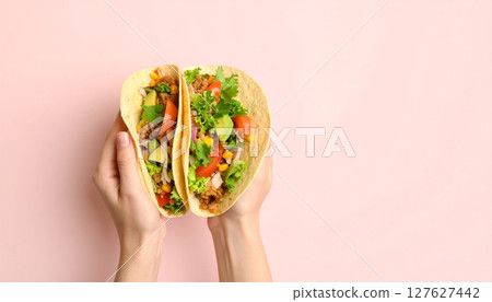 Hands holding colorful Easter eggs alongside a plate of fresh salad with green vegetables, tomatoes, and bruschetta Hands holding colorful Easter eggs alongside a plate of fresh salad with green vegetables, tomatoes, and bruschetta 127627442