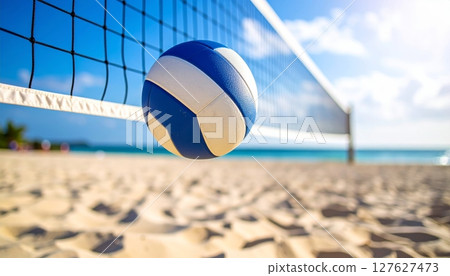 Colorful volleyball on a sandy beach with a net, under a summer sky by the blue ocean, ready for fun Colorful volleyball on a sandy beach with a net, under a summer sky by the blue ocean, ready for fun 127627473