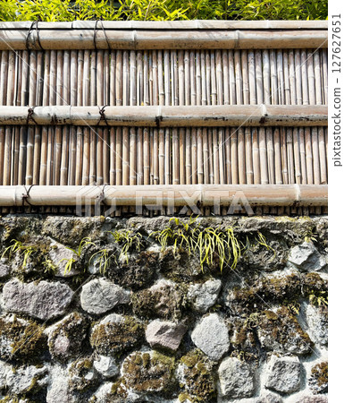 Japanese style stone and bamboo fence Japanese style stone and bamboo fence 127627651