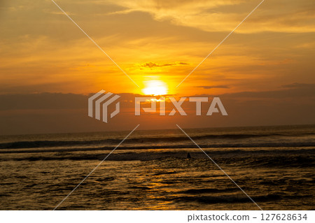 Golden Sunset Silhouette Over Sea with Waves and Cloudy Sky, Sumatra Beach, Lampung 127628634