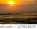 Sunset in Sumatra, Lampung with silhouettes of local children surfing, the Indian open sea is famous for its big waves 127628635