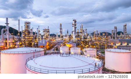 Aerial view oil storage tank petrochemical storage tank with oil refinery background at night, Oil refinery oil storage tank illuminated at night, Oil refinery petrochemical storage tank industrial 127628808