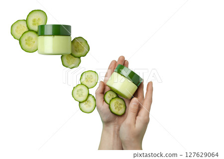 Hands hold skin cream and cucumber slices, isolated on white, PNG Hands hold skin cream and cucumber slices, isolated on white, PNG 127629064