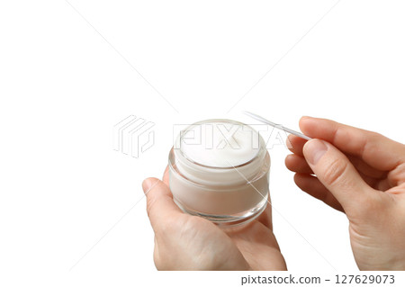 Preparing to apply a rich moisturizing cream, isolated on white, PNG Preparing to apply a rich moisturizing cream, isolated on white, PNG 127629073