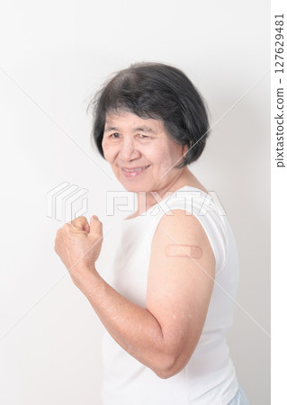 Elderly Woman with bandage after received vaccine. Vaccination and Immunization for Influenza, Herpes Zoster, Tetanus, Covid 19 booster, Dengue, Encephalitis, Rabies, Pneumococcal, IPD, RSV Vaccines 127629481