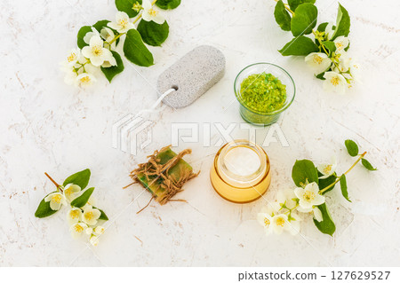 Body care products and branches of jasmine on the white background. 127629527