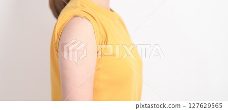 Adult Woman with bandage after received vaccine. Vaccination and Immunization for Influenza, HPV, Zoster, IPD, DTP or Diphtheria, Tetanus and Pertussis, MMR, Hepatitis B, Covid and Varicella vaccine 127629565