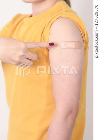 Adult Woman with bandage after received vaccine. Vaccination and Immunization for Influenza, HPV, Zoster, IPD, DTP or Diphtheria, Tetanus and Pertussis, MMR, Hepatitis B, Covid and Varicella vaccine Adult Woman with bandage after received vaccine. Vaccination and Immunization for Influenza, HPV, Zoster, IPD, DTP or Diphtheria, Tetanus and Pertussis, MMR, Hepatitis B, Covid and Varicella vaccine 127629570