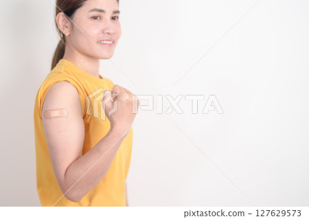 Adult Woman with bandage after received vaccine. Vaccination and Immunization for Influenza, HPV, Zoster, IPD, DTP or Diphtheria, Tetanus and Pertussis, MMR, Hepatitis B, Covid and Varicella vaccine 127629573
