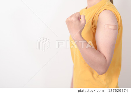 Adult Woman with bandage after received vaccine. Vaccination and Immunization for Influenza, HPV, Zoster, IPD, DTP or Diphtheria, Tetanus and Pertussis, MMR, Hepatitis B, Covid and Varicella vaccine 127629574