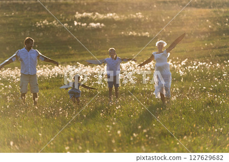 Young family with small children playing on a meadow in nature. Young family with small children playing on a meadow in nature. 127629682